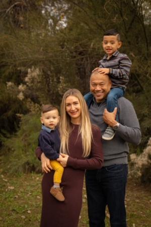 Family of 4 posing outside