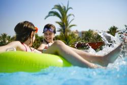 Two girls on pool floats
