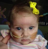 Infant with yellow bow in hair