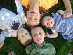 Four siblings looking up at camera