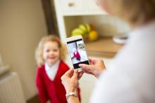 Parent taking photo of child with cellphone