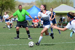 Teen girl playing soccer