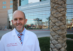 Dr. Muenzer in front of hospital