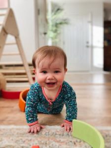 Smiling baby crawling toward camera