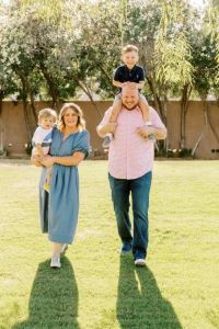 Family of 4, smiling at camera