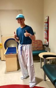 Teen giving thumbs up sign
