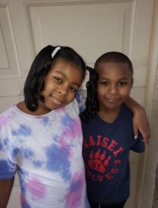 Brother and sister posing together