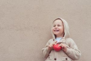 Child holding a small red ball