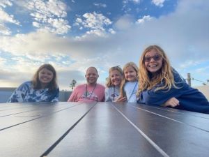 Family of 5 sitting outside
