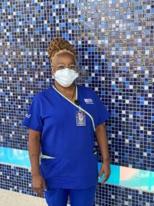 Masked provider in blue scrubs