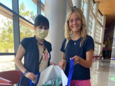 Two females holding an open bag of goodies