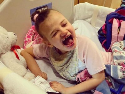 Smiling girl in hospital bed
