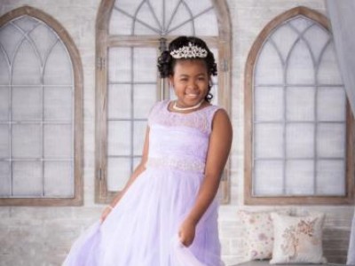 Young girl in white gown and tiara