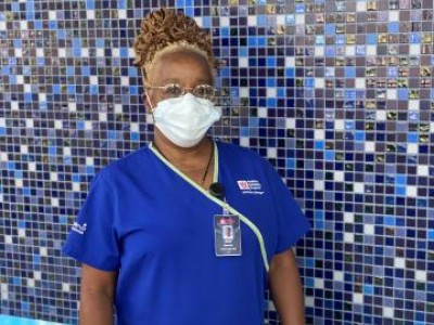 Masked provider in blue scrubs