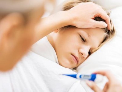 Sick child in bed, thermometer