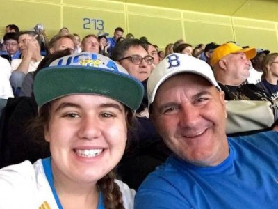 Teen and father at baseball game