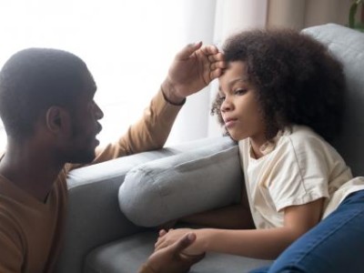 Father feeling child's forehead