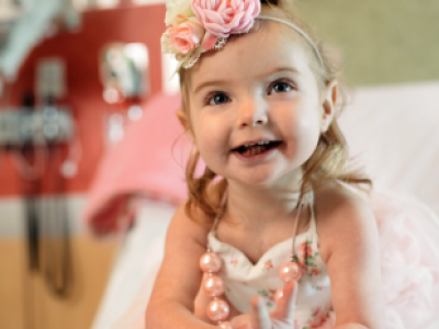Toddler girl in fancy dress with flowers on her head