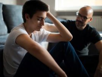 Father and son sitting on floor together