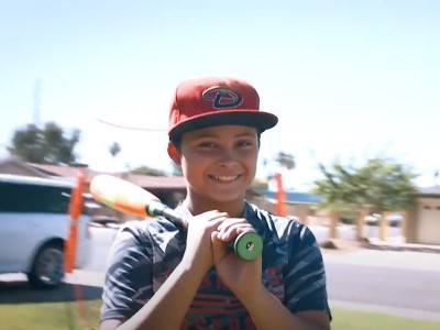 Boy with baseball bat on his shoulder