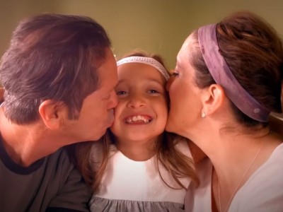 Child flanked by mother and father