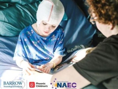 Child in hospital bed with netting on head