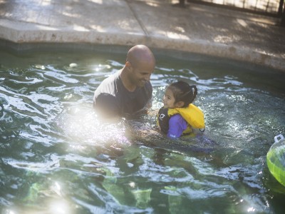 Father and daughter in swimming pool