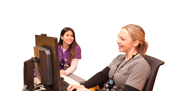 Nurses talking at work station