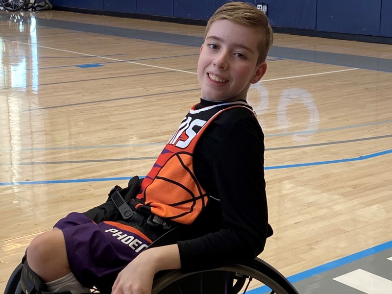 Boy in wheelchair on basketball court