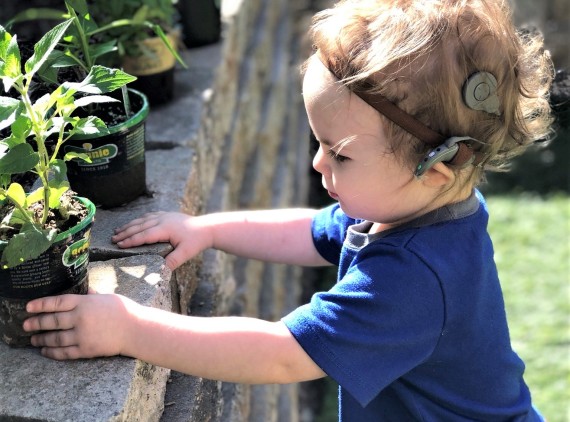Toddler wearing cochlear implant