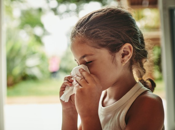 Girl blowing her nose