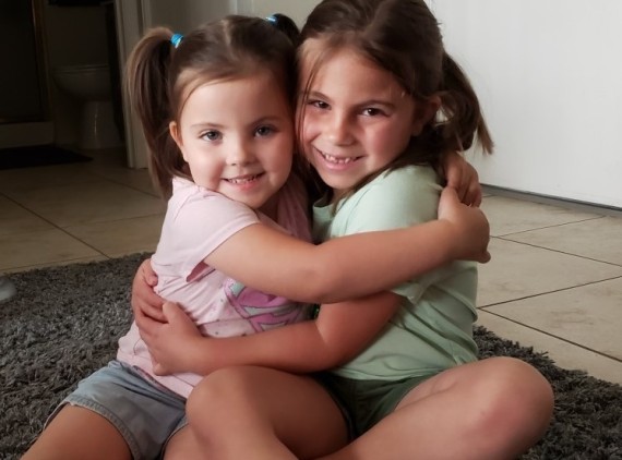 Two sisters hugging