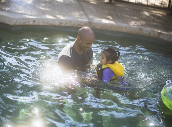 Father and daughter in swimming pool